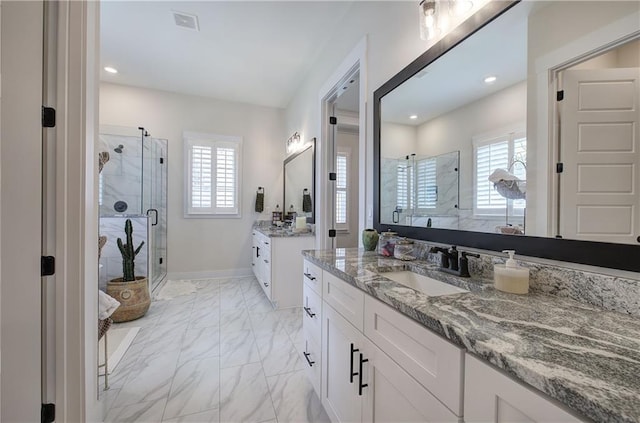 884 Oxford Rd, Ball Ground, GA 30107 - bathroom with a shower stall, marble look tile flooring, two vanities, and recessed lighting