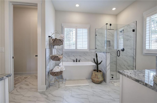 884 Oxford Rd, Ball Ground, GA 30107 - full bath featuring marble finish floors, a marble finish shower, a soaking tub, recessed lighting, and vanity