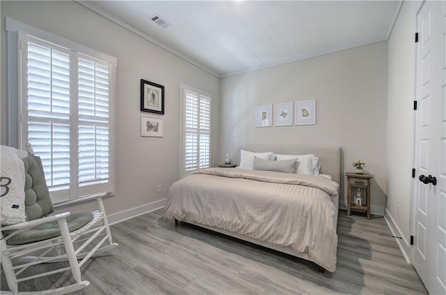 884 Oxford Rd, Ball Ground, GA 30107 - bedroom featuring light wood-type flooring and ornamental molding