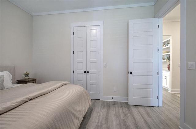 884 Oxford Rd, Ball Ground, GA 30107 - bedroom with light wood-style floors, a closet, and crown molding