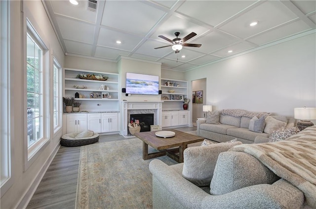 884 Oxford Rd, Ball Ground, GA 30107 - living area featuring plenty of natural light, wood finished floors, a ceiling fan, crown molding, and coffered ceiling