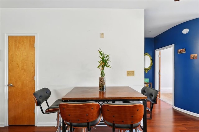 dining room with baseboards and wood finished floors