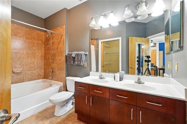 bathroom with tile patterned flooring,  shower combination, double vanity, toilet, and a sink
