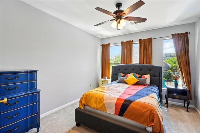 bedroom featuring carpet, baseboards, and multiple windows