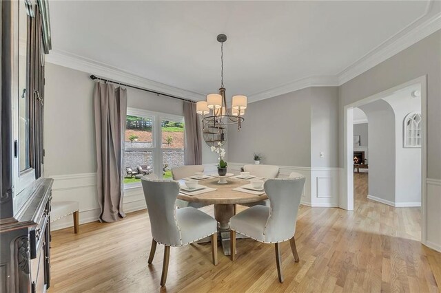 809 Hillcrest Ln, Woodstock, GA 30189 - dining area featuring a chandelier, light wood-style flooring, crown molding, and wainscoting