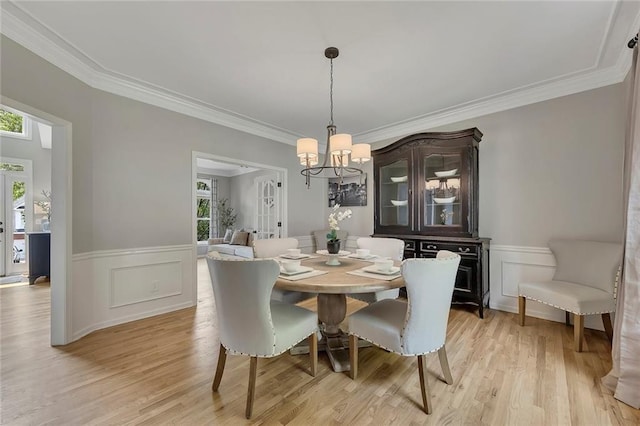 809 Hillcrest Ln, Woodstock, GA 30189 - dining area featuring a chandelier, light wood-style flooring, crown molding, and wainscoting