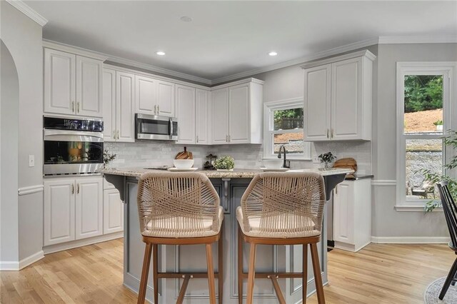 809 Hillcrest Ln, Woodstock, GA 30189 - kitchen featuring stainless steel dishwasher, a sink, white cabinetry, crown molding, and dark stone countertops