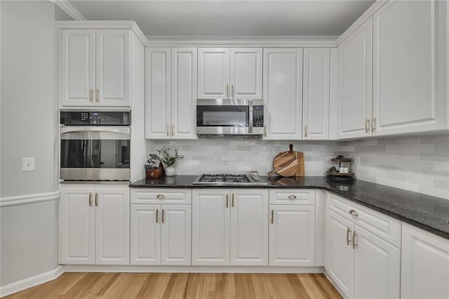 809 Hillcrest Ln, Woodstock, GA 30189 - kitchen with stainless steel appliances, white cabinets, and backsplash