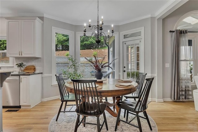 809 Hillcrest Ln, Woodstock, GA 30189 - dining area with light wood-style flooring, a chandelier, crown molding, and baseboards
