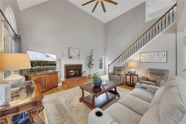 809 Hillcrest Ln, Woodstock, GA 30189 - living area featuring high vaulted ceiling, a ceiling fan, wood finished floors, a fireplace, and stairs