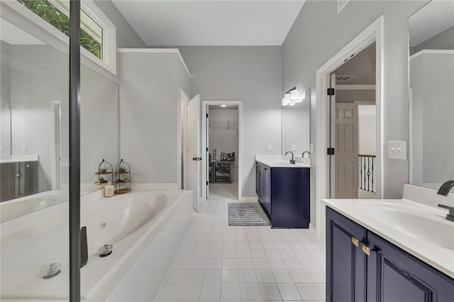 809 Hillcrest Ln, Woodstock, GA 30189 - bathroom with tile patterned floors, two vanities, a tub with jets, and a spacious closet