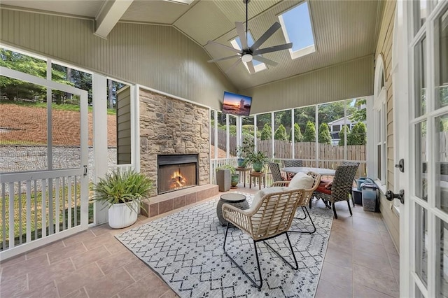 809 Hillcrest Ln, Woodstock, GA 30189 - sunroom with an outdoor stone fireplace, a ceiling fan, a skylight, and lofted ceiling