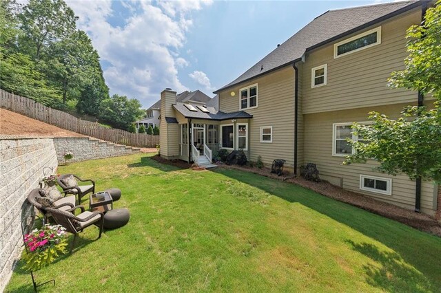 809 Hillcrest Ln, Woodstock, GA 30189 - rear view of house with a sunroom, a yard, and a chimney