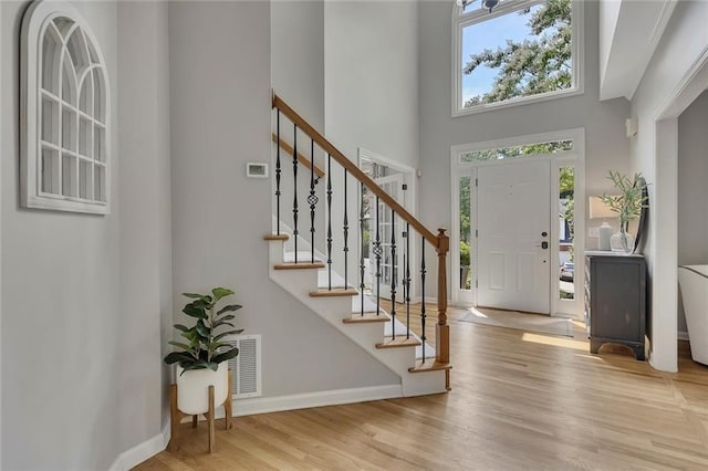 809 Hillcrest Ln, Woodstock, GA 30189 - entryway featuring a towering ceiling, baseboards, stairs, and wood finished floors