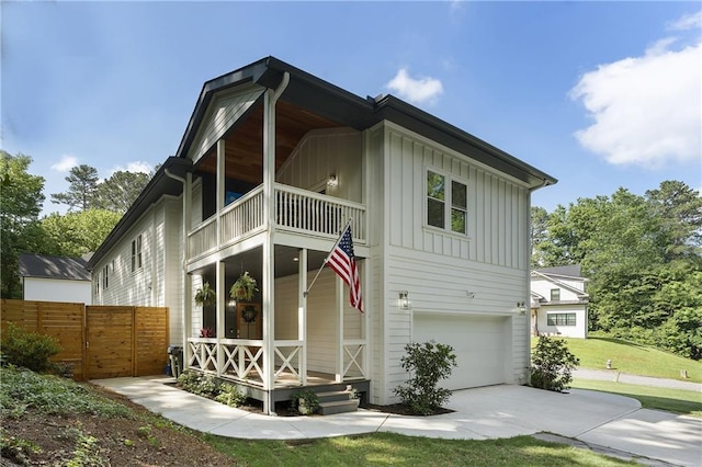 3899 Carlton Dr, Chamblee, GA 30341 - view of front of home with a balcony, board and batten siding, a garage, and driveway