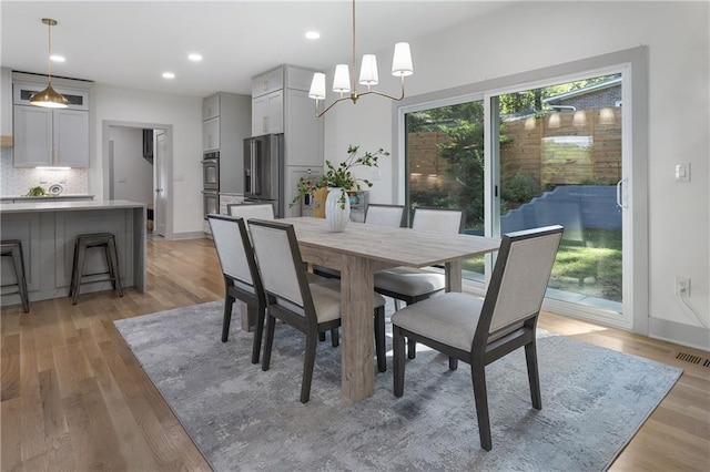 3899 Carlton Dr, Chamblee, GA 30341 - dining room featuring light wood-type flooring, recessed lighting, and a chandelier