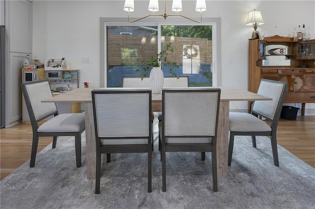 3899 Carlton Dr, Chamblee, GA 30341 - dining room featuring a chandelier and light wood finished floors