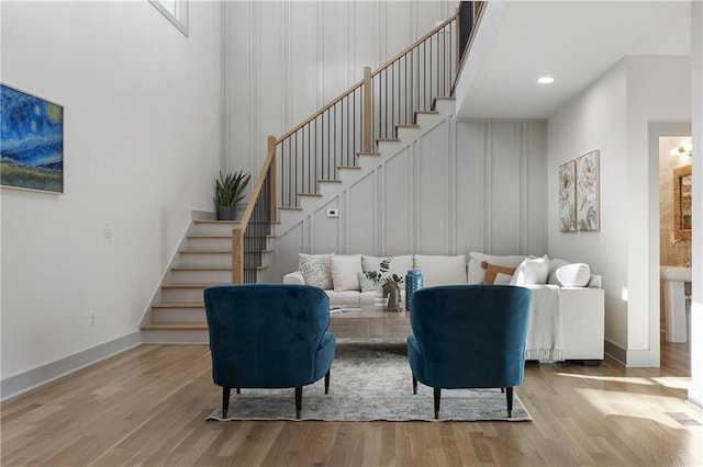 3899 Carlton Dr, Chamblee, GA 30341 - living area with stairs, wood finished floors, a decorative wall, and recessed lighting