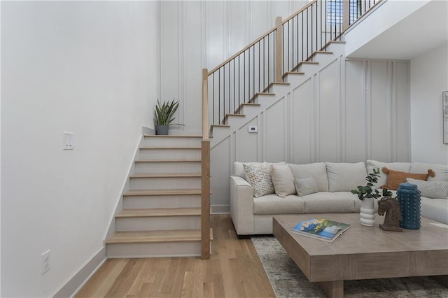 3899 Carlton Dr, Chamblee, GA 30341 - living area with wood finished floors, stairway, and a high ceiling