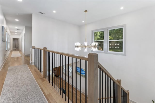 3899 Carlton Dr, Chamblee, GA 30341 - hallway with a chandelier, wood finished floors, and recessed lighting