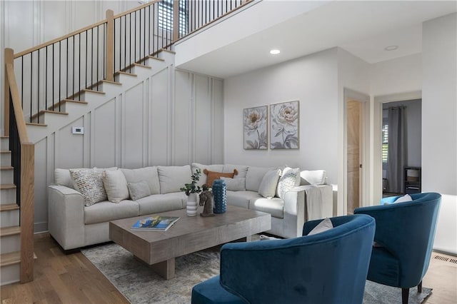 3899 Carlton Dr, Chamblee, GA 30341 - living room featuring wood finished floors, stairway, recessed lighting, and a decorative wall