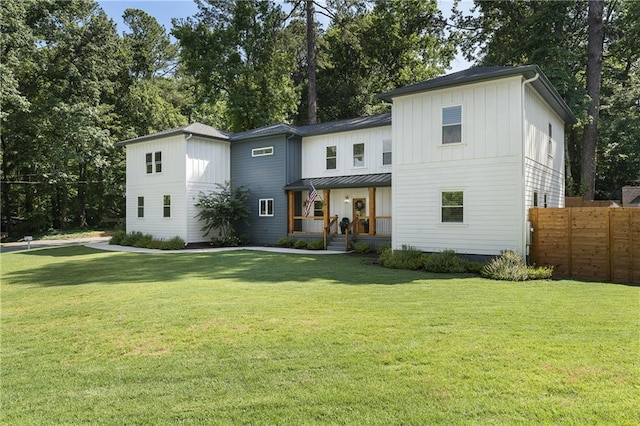 3899 Carlton Dr, Chamblee, GA 30341 - modern farmhouse style home with a porch, board and batten siding, a standing seam roof, and view of wooded area