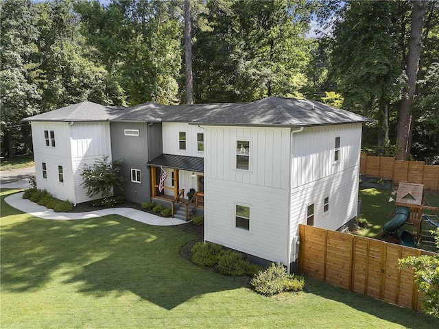 3899 Carlton Dr, Chamblee, GA 30341 - view of front of house with roof with shingles, view of wooded area, covered porch, and board and batten siding