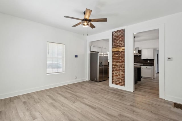 interior space with ceiling fan and light wood-type flooring