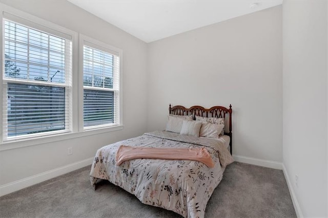 carpeted bedroom featuring baseboards
