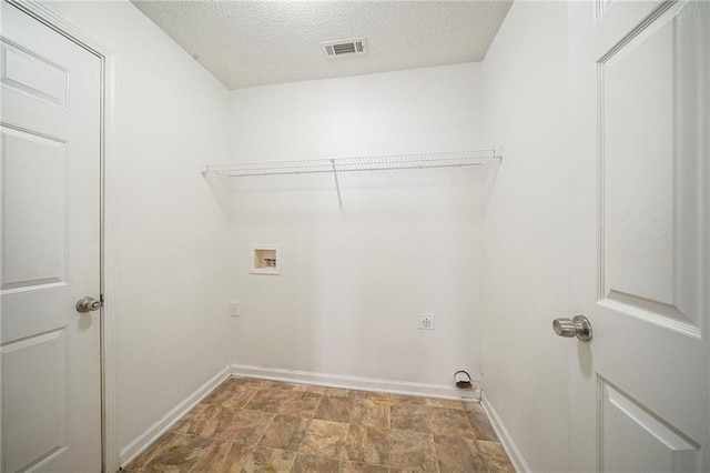 laundry room featuring a textured ceiling, hookup for a washing machine, laundry area, visible vents, and electric dryer hookup