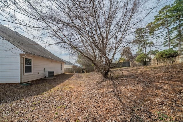 view of yard with cooling unit and fence