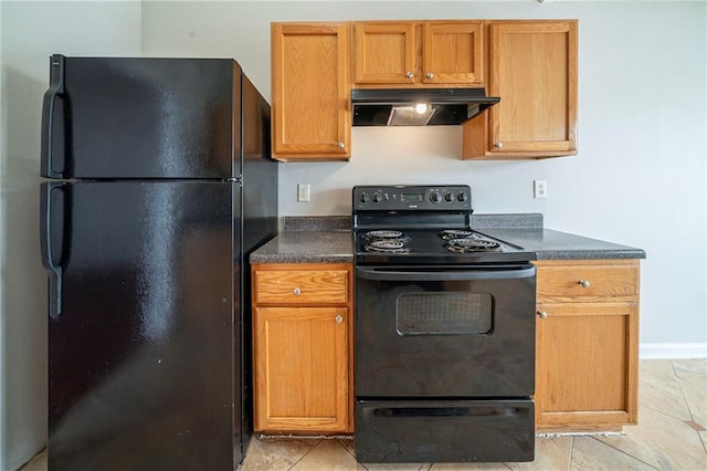 kitchen with dark countertops, black appliances, under cabinet range hood, and light tile patterned floors