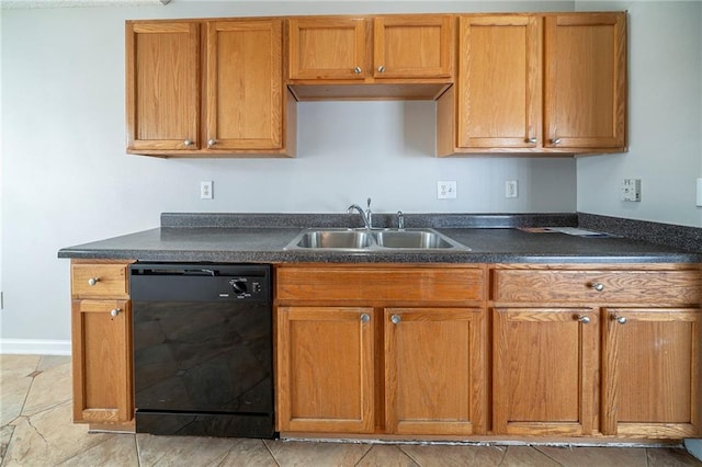 kitchen with dark countertops, black dishwasher, brown cabinets, and a sink