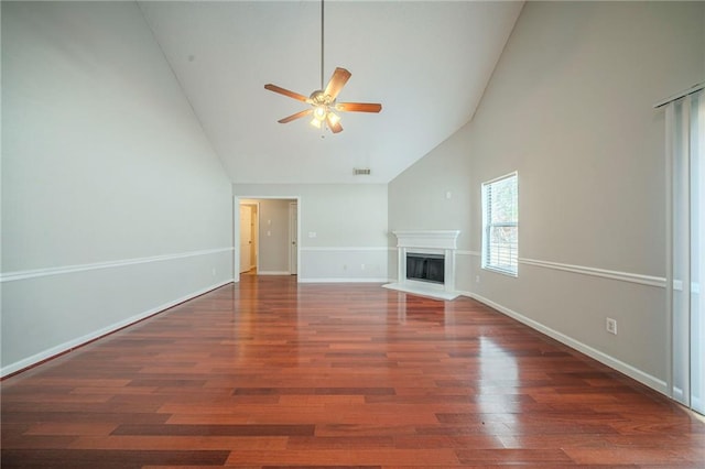 unfurnished living room with baseboards, a ceiling fan, wood finished floors, a fireplace, and high vaulted ceiling