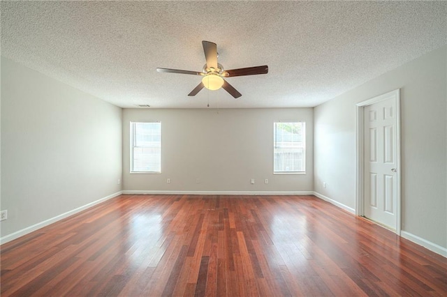 unfurnished room featuring ceiling fan, a textured ceiling, wood finished floors, and baseboards