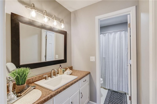 bathroom with vanity, toilet, and walk in shower