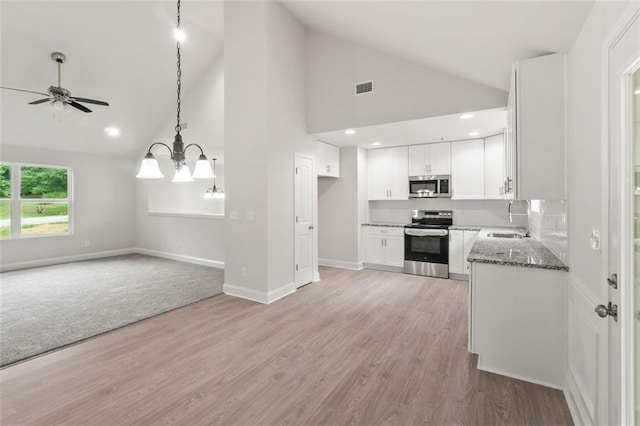 5209 Waterworks Rd, Jefferson, GA 30549 - kitchen featuring stainless steel appliances, a sink, open floor plan, a ceiling fan, and high vaulted ceiling