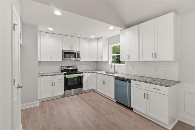 5209 Waterworks Rd, Jefferson, GA 30549 - kitchen with appliances with stainless steel finishes, a sink, light wood-style flooring, light stone countertops, and lofted ceiling