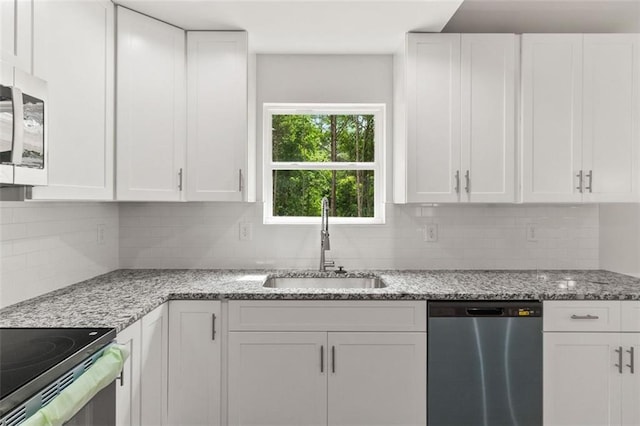 5209 Waterworks Rd, Jefferson, GA 30549 - kitchen featuring stainless steel appliances, a sink, white cabinetry, decorative backsplash, and light stone countertops