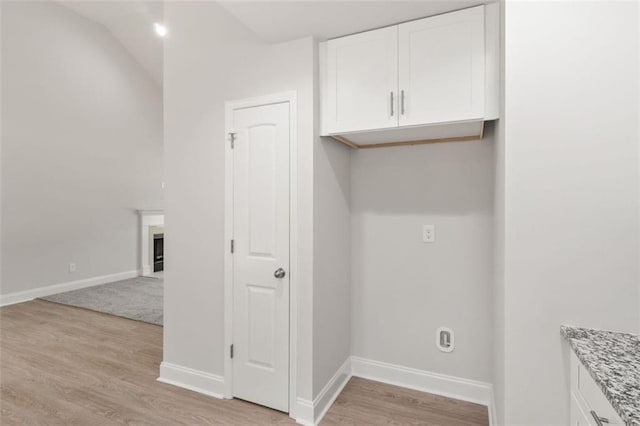 5209 Waterworks Rd, Jefferson, GA 30549 - laundry room with light wood-style flooring, baseboards, and a fireplace