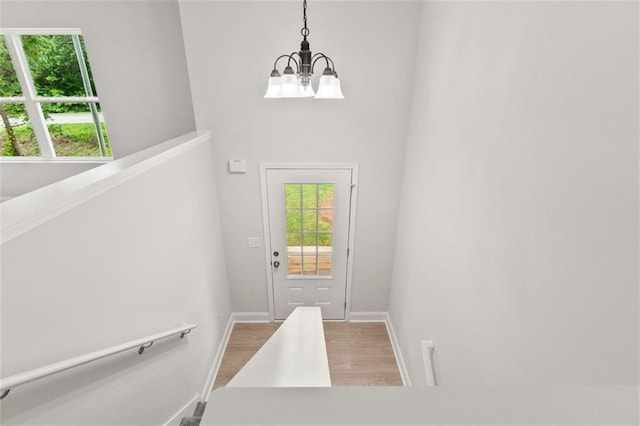 5209 Waterworks Rd, Jefferson, GA 30549 - doorway to outside with a chandelier, wood finished floors, healthy amount of natural light, and baseboards