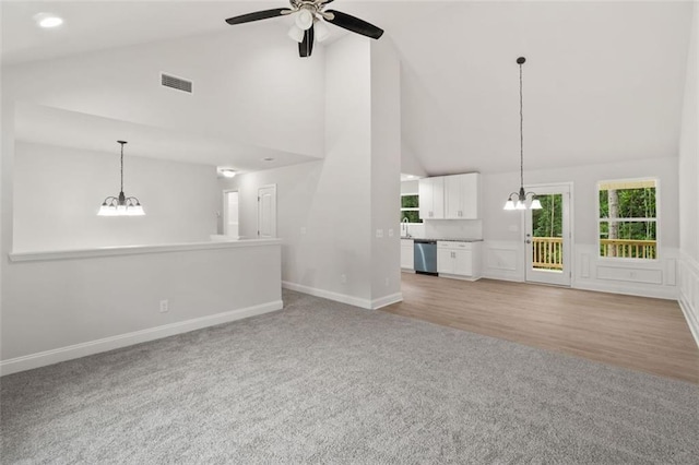 5209 Waterworks Rd, Jefferson, GA 30549 - unfurnished living room featuring light carpet, a chandelier, high vaulted ceiling, ceiling fan, and baseboards