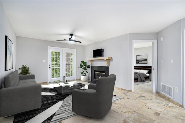 living room with ceiling fan and light tile patterned floors