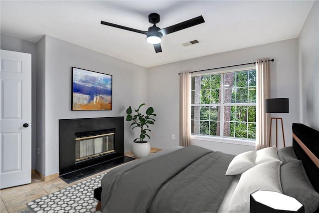 tiled bedroom featuring ceiling fan