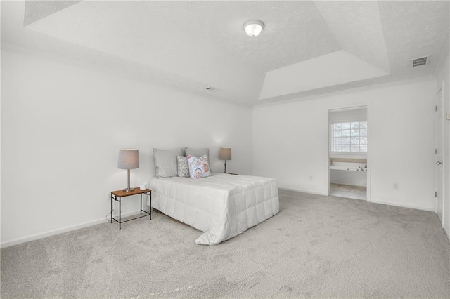 bedroom with carpet, a textured ceiling, visible vents, a raised ceiling, and baseboards