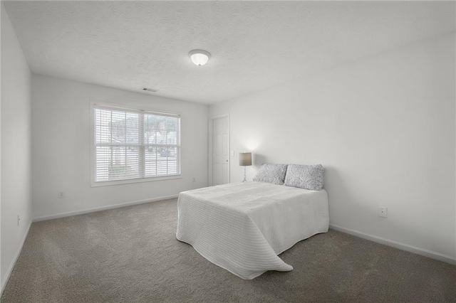 bedroom with visible vents, baseboards, and carpet floors