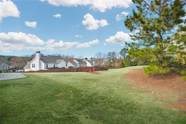 view of yard with a residential view and fence