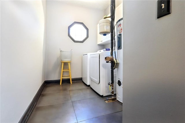 clothes washing area with laundry area, washing machine and clothes dryer, and baseboards