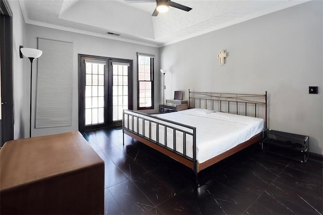 bedroom with a ceiling fan, a tray ceiling, visible vents, and crown molding