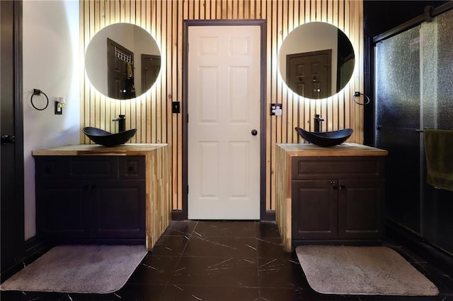 doorway to outside with marble finish floor and a sink